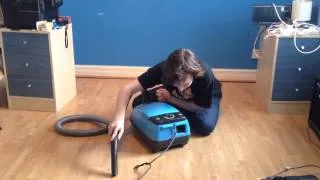 Rhys Morgan uses a vacuum cleaner