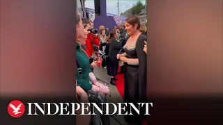 Olivia Colman impressed by fan's tattoo of her face during red carpet meeting