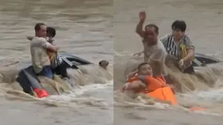 Firefighters rescue couple trapped on minivan in flash floods in E China