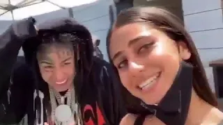 6ix9ine posing with a super model