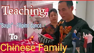 Chinese family dancing traditional Filipino dance "Bayle".