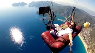 Guy Paraglides With Sofa and TV Set