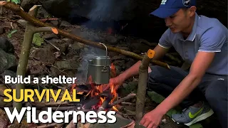 Build a survival shelter out of wood at the wilderness waterfall | Grilled Crab Bushcraft & Campfire