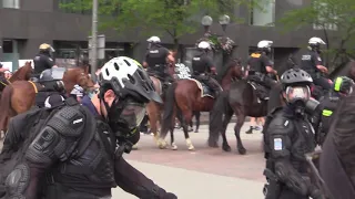 A group of protesters are pepper sprayed in downtown Columbus, Ohio.