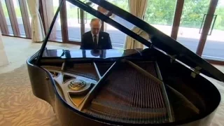 Putin plays piano while awaiting Chinese leader Xi Jinping, Beijing