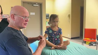 Raynor massage for children. Naturopath Brandon Raynor demonstrating how to massage Ellie.