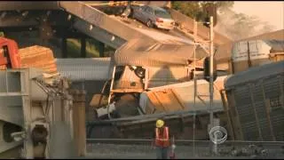 Train collision brings down highway overpass