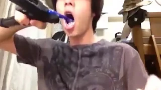 Kid brushes his teeth with an airsoft gun