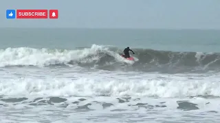 Surfing at Waikuku Beach. New Zealand, South Island.