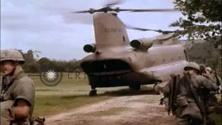 CH-47 Chinook helicopters in flight and soldiers unload M102 105mm Howitzer from ...HD Stock Footage