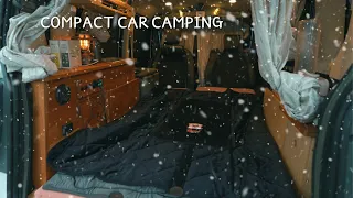 Staying overnight in a compact camping car on a snowy day