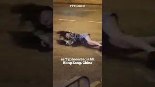 Woman blown to ground by strong winds in Hong Kong