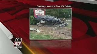 Car crashes into fence, rock