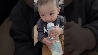 Baby Theo starting to hold his bottle on his own