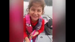 Little girl catches fish with Barbie fishing pole