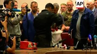 A Ukrainian separatist leader handed over black boxes from flight MH17 to Malaysia officials in Done