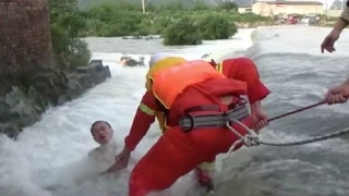 Motorcyclist Rescued From Rapid Flood in South China's Guangxi