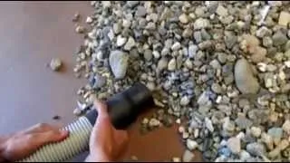 Single phase industrial vacuum cleaner picking up rocks