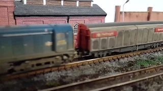 BR blue Class 20 slowly makes its way across a sleepy industrial area