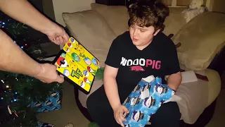 Tristan opening a gift on Christmas Eve 2017