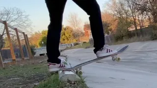 Skating a curb at a ditch by my crib