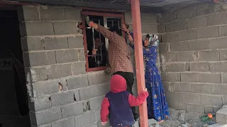 "Master builder Akbar beautifies Jamila's house with doors and windows that the cameraman buys"