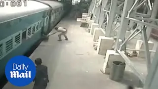 Hero policeman saves woman from slipping under a moving train