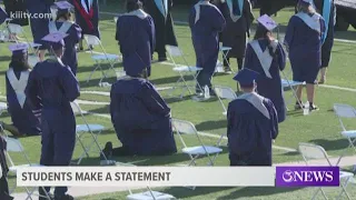 Local students peacefully protest during national anthem at Cabaniss Field graduation ceremony