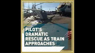 Pilot’s dramatic rescue as train approaches