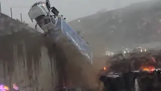 Truck tumbles over side of CA freeway, lands on wreckage from earlier crash | VIDEO