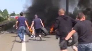 AP footage of striking ferry workers burning tyres