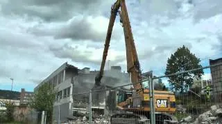 CAT 365C High Reach Demolishing a building