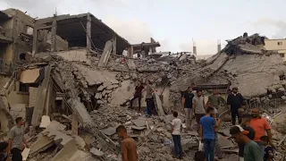 Gazans search through the rubble following Israeli strike on Deir El-Balah | AFP