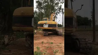 Excavator digging out stump