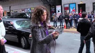 Steven Tyler of Aerosmith poses with the new CD outside o...