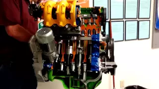 Engine cut in half and driven by electric motor so you can see how it works