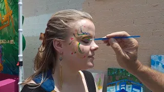 Painting a face at The Deep Ellum  Community Arts Fair