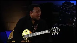 George Benson playing along the neck