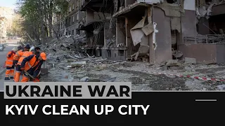 Resilient Kyiv residents clean up city after Russian missile attack