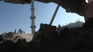 People going through rubble of residential building, grieving dead following Israeli strikes in Rafa