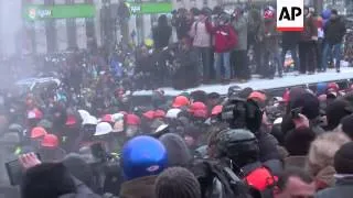 Hundreds of protesters clash with riot police after passage of anti-protest law