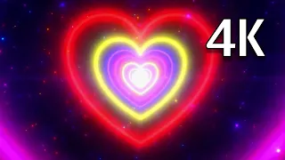 Very bright neon hearts video background footage on the screen Neon hearts tunel 4K