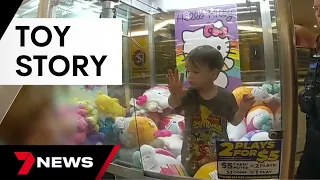 Three-year-old boy gets stuck inside a claw machine full of toys | 7 News Australia