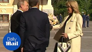 Putin gifts Brigitte Macron flowers as Emmanuel Macron visits Russia