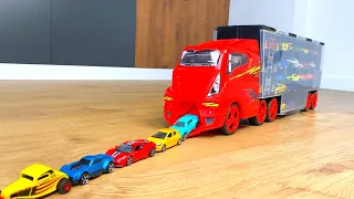 Cars Sliding Down From Big Red Truck Transporter