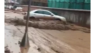 Floodwater Washes away Cars in Southwest China