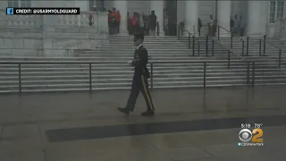 Soldier Places Flags Despite Stormy Downpour