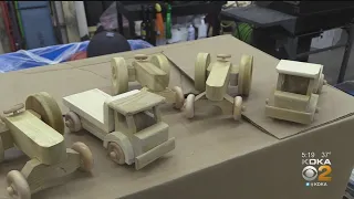 Man Makes Wooden Toy Trucks For Kids In The Area