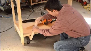Workbench that levers up onto dollies for easy moving