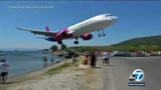 Video: Jet lands dangerously close to 'planespotters' at airport in Greece l ABC7